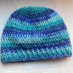 Handmade With Lion Brand Ice Cream Yarn Beautiful Blue And Green Colors Blue Fitted Casual Beanie, Blue Knitted Hat For Spring, Blue Knitted Beach Hat, Blue Acrylic Yarn Winter Hat, Blue Hand Knitted Hats For Spring, Casual Blue Knitted Hat, One Size Blue Beanie Cap, Casual Blue Acrylic Yarn Hat, Blue Yarn Hats For Spring