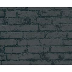 an old brick wall with dark grey paint on the top and bottom, as well as black