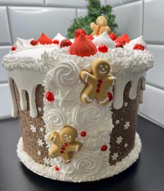 a decorated christmas cake with gingerbreads and icing