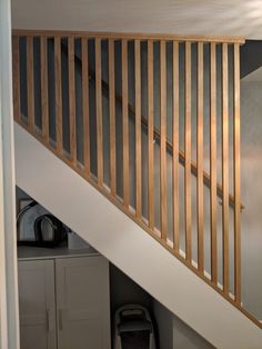 the stairs are made of wood and have no railings or rails, but there is also a storage space underneath them