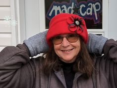 a woman wearing a red hat and sunglasses