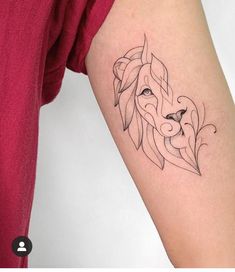 a woman's arm with a tattoo on it that has an image of a lion