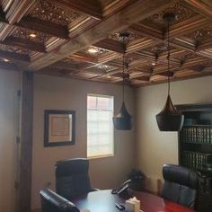 an empty conference room with wooden ceilings and leather chairs