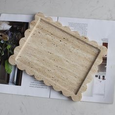 a wooden tray sitting on top of a magazine