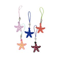 three starfish shaped key chains are hanging from strings on a white background, one is pink, the other is blue