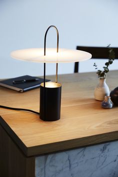 a table lamp sitting on top of a wooden counter