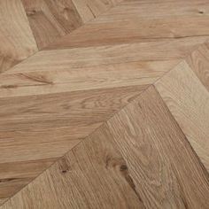 an image of wood flooring that looks like herringbones or chevrons