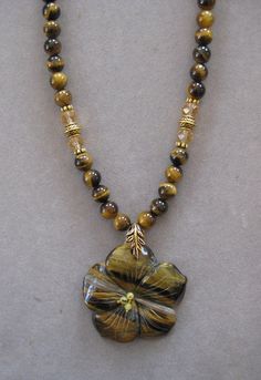 This is a beautiful Stone Hand Carved  Tiger Eye Pendant Necklace. These stones are very rare and hard to find. It is 16 inches long and adjustable to 21 inches with a lobster clasp and chain. The pendant measures 2 inches wide. The beads in the chain are genuine Tiger Eye and match the pendant stone.    All my jewelry is unique and one of a kind. Similar quality jewelry is priced at double. I source the stone pendants from all over the world. All pendants and necklaces are made with semipreciou Tiger Pearl Necklace, Flying Tiger Pearl Necklace, Jean Art, African Bloodstone, Bracelet Craft, Eye Pendant Necklace, Cherry Quartz, Bracelet Craft Diy, Dragon Vein Agate