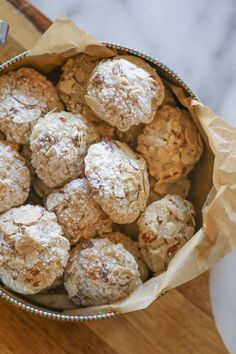 a bowl filled with cookies sitting on top of a wooden table