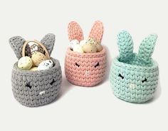 three crocheted baskets filled with eggs and bunnies, one in the shape of an easter basket