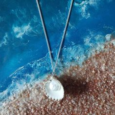 Embrace the beauty of the ocean with our handcrafted Seaside Elegance necklace, a stunning piece that captures the essence of the shore. This necklace features a natural seashell pendant, carefully selected for its unique shape and intricate patterns, paired with a lustrous freshwater pearl that adds a touch of elegance. Each necklace is lovingly handcrafted, ensuring that no two pieces are exactly alike--just like the treasures you find on the beach. The combination of organic elements and timeless pearls creates a perfect harmony, making this necklace a versatile accessory that can complement any outfit, whether you're dressing up for a special occasion or adding a touch of coastal charm to your everyday look. Features: Natural Seashell: Handpicked for its distinctive beauty, bringing th Ocean-inspired Shell Necklaces For Gifts, Shell-shaped Jewelry With Pearl Pendant, Shell-shaped Pearl Pendant Jewelry, Ocean-inspired Pearl Necklace For Beach, Shell Jewelry With Pearl Pendant, Ocean-inspired Shell-shaped Jewelry Gift, Bohemian Silver Jewelry For Beach Wedding, Ocean-inspired Shell-shaped Necklace With Pearl Pendant, Shell-shaped Sterling Silver Jewelry For Beach