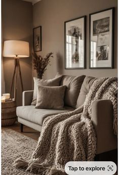 a living room filled with furniture and pictures hanging on the wall above it's couch