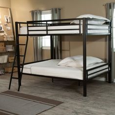 a bunk bed with two sets of mattresses on the bottom, and a ladder to the top