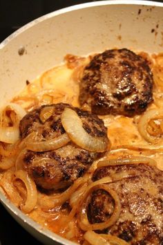 some meatballs and onions are cooking in a skillet