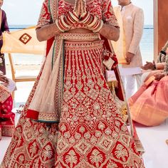 a man in a red and gold wedding outfit