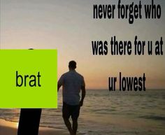 a man standing on top of a beach next to the ocean with a green sign