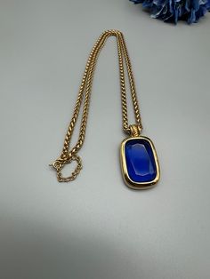 Joan Rivers Classic Collection Pendant Necklace with Sapphire Blue Lucite Stone.  The pendant on this necklace allows for you to change out the stone - however, I only have one stone, the one pictured for this piece.  This is a beautiful piece - the gold and blue are rich and elegant.  The piece is in wonderful condition.  The basketweave chain is 29" - 31" adjustable.  The pendant is 2" by 1.25".  Packaged for gifting. Blue Stone Necklace, Joan Rivers, Sapphire Blue, Classic Collection, Blue Stone, Stone Necklace, One Pic, Basket Weaving, Blue Sapphire