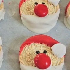 some cupcakes are decorated like santa claus's hat and nose with red noses