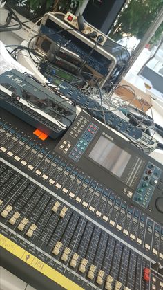 there are many sound mixing equipment on the table