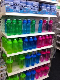 the shelves are filled with many different colored water bottles and plastic cups, along with one another