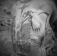 a man's back is covered with drawings and words from the bible on paper