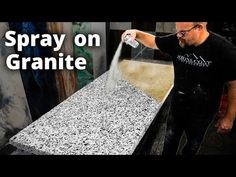 a man sprays water on granite counter tops in an art studio with the words spray on granite