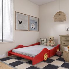 a child's bedroom with a red bed and checkered rug on the floor