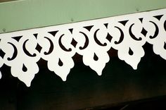 a close up view of the top part of a wooden structure with white paint on it