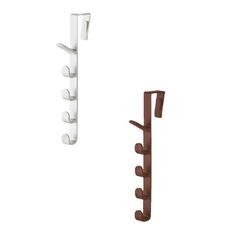 two white and brown wall hooks on the side of each hook, one holding a coat rack