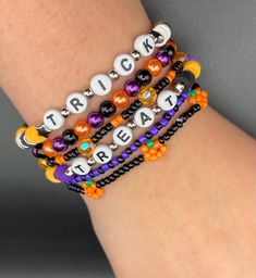 the bracelets are decorated with beads and letters that spell out trick or treat on them