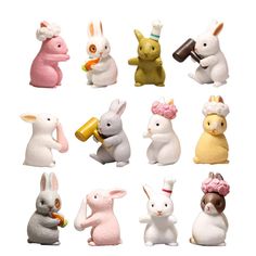 many different types of small toy animals on a white background, including rabbits and bunnies