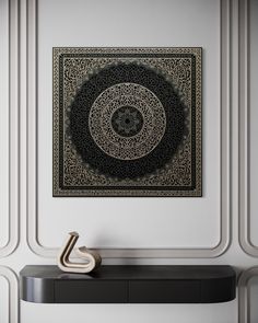 a black and white wall hanging above a table