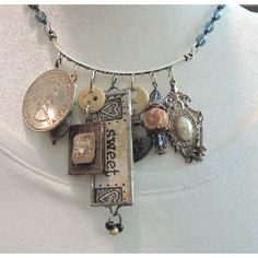 a necklace with buttons and charms hanging from it