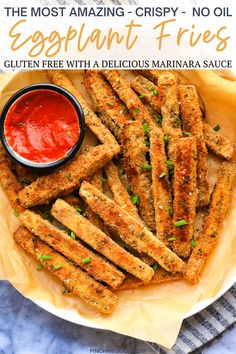 baked eggplant fries on a plate with ketchup and sauce in the background