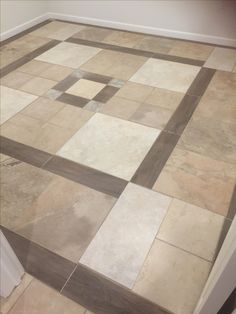 a tile floor with several different colors and shapes in the center, including squares on each side