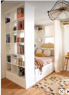 a bedroom with bookshelves and a bed in it