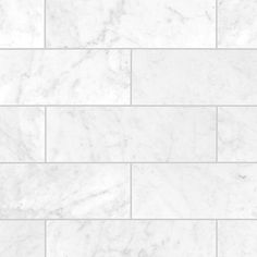 a white marble tile wall that looks like it is being used as a floor covering