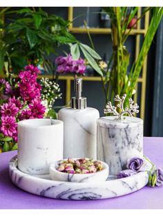 marble bathroom accessories sitting on top of a purple table