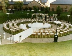 an outdoor ceremony setup with chairs and tables