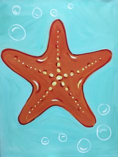 an orange starfish floating on top of blue water