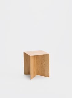 a small wooden table sitting on top of a white surface