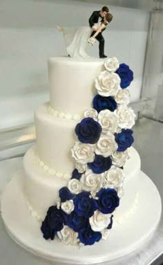 a wedding cake with blue and white flowers on top is shown in an instagram