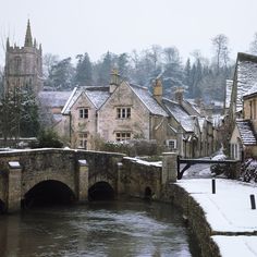 a bridge over a river with snow on the ground