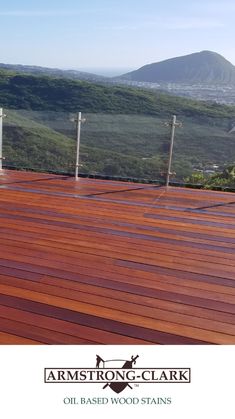 a wooden deck with mountains in the background and text that reads, armstrong & clark oil based wood stains