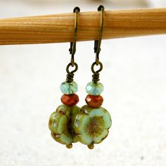 "This listing is for these vintage style, glass beaded, dangle earrings. They are wonderful mint green flower beads, orange brown, and a pale aqua with a touch of green. They are part of my coral pink and mint series. All the items from this series can mix and match. These earrings are 1.5 inches in length. They are light weight and comfortable. The smaller bead is 3 x 5mm in size, the Hibiscus flower bead is 12mm. This is available in a vintage look with antique brass (as shown), hypoallergenic Vintage Hypoallergenic Drop Earrings, Hypoallergenic Vintage Drop Earrings, Retro Beaded Dangle Jewelry, Nickel-free Vintage Drop Beaded Earrings, Adjustable Retro Drop Earrings, Vintage Nickel-free Drop Beaded Earrings, Retro Adjustable Drop Earrings, Handmade Czech Glass Vintage Earrings, Vintage Czech Glass Beaded Earrings As Gift