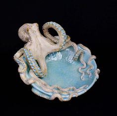 an octopus is sitting on top of a bowl