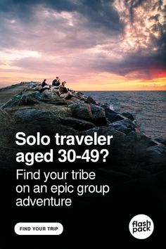 an advertisement for a travel company with people sitting on rocks near the ocean at sunset