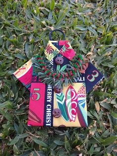 an ornament is laying in the grass on top of some leaves and berries