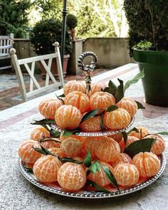 there are several oranges stacked on top of each other in the middle of a table