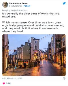 an old town with people walking down the street